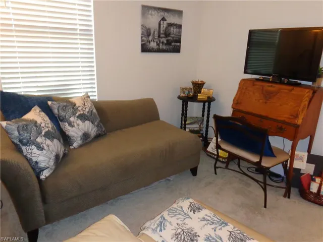 a bedroom with a bed and chair