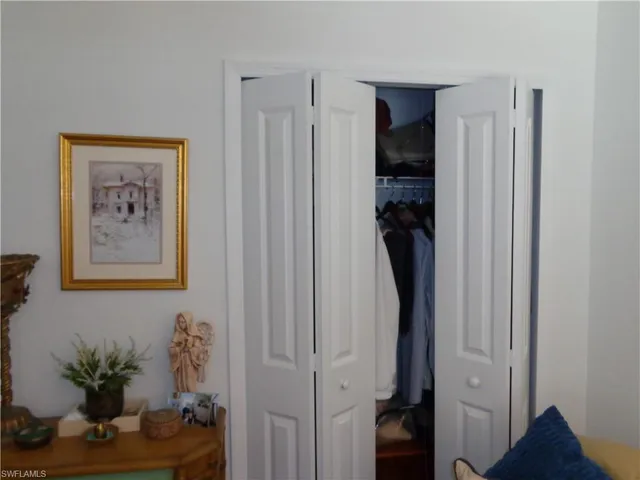 a view of a hallway with closet and wooden floor