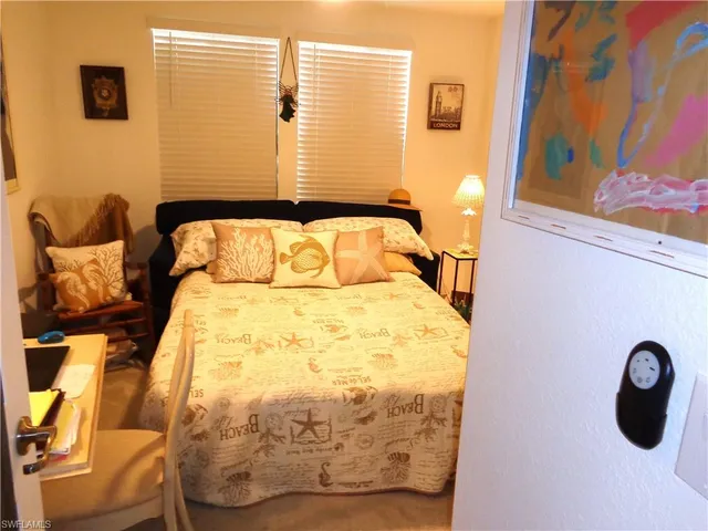 a bedroom with a bed and wall painting