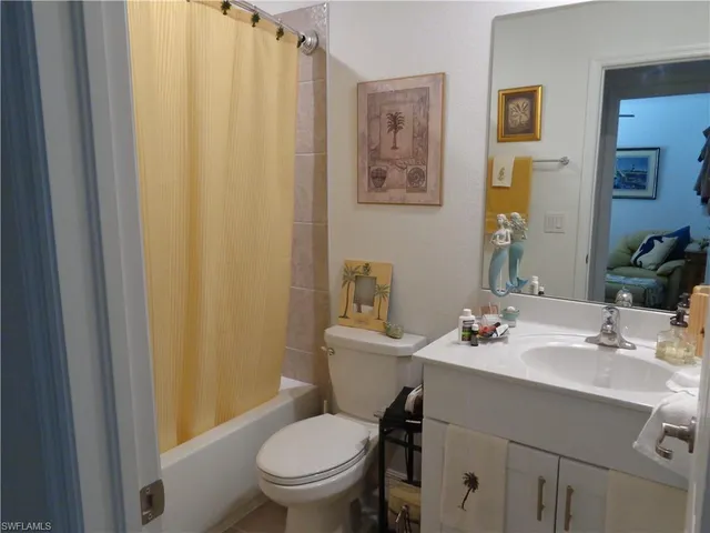 a bathroom with a sink mirror and toilet