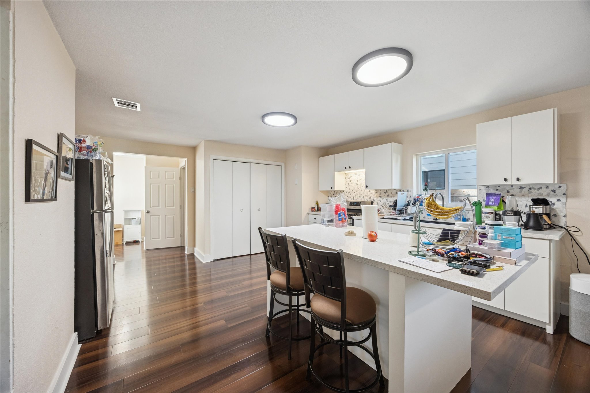 907 East 53rd Street Austin, TX 78751 - Photo 9 of 35 a kitchen with a dining table chairs refrigerator and cabinets