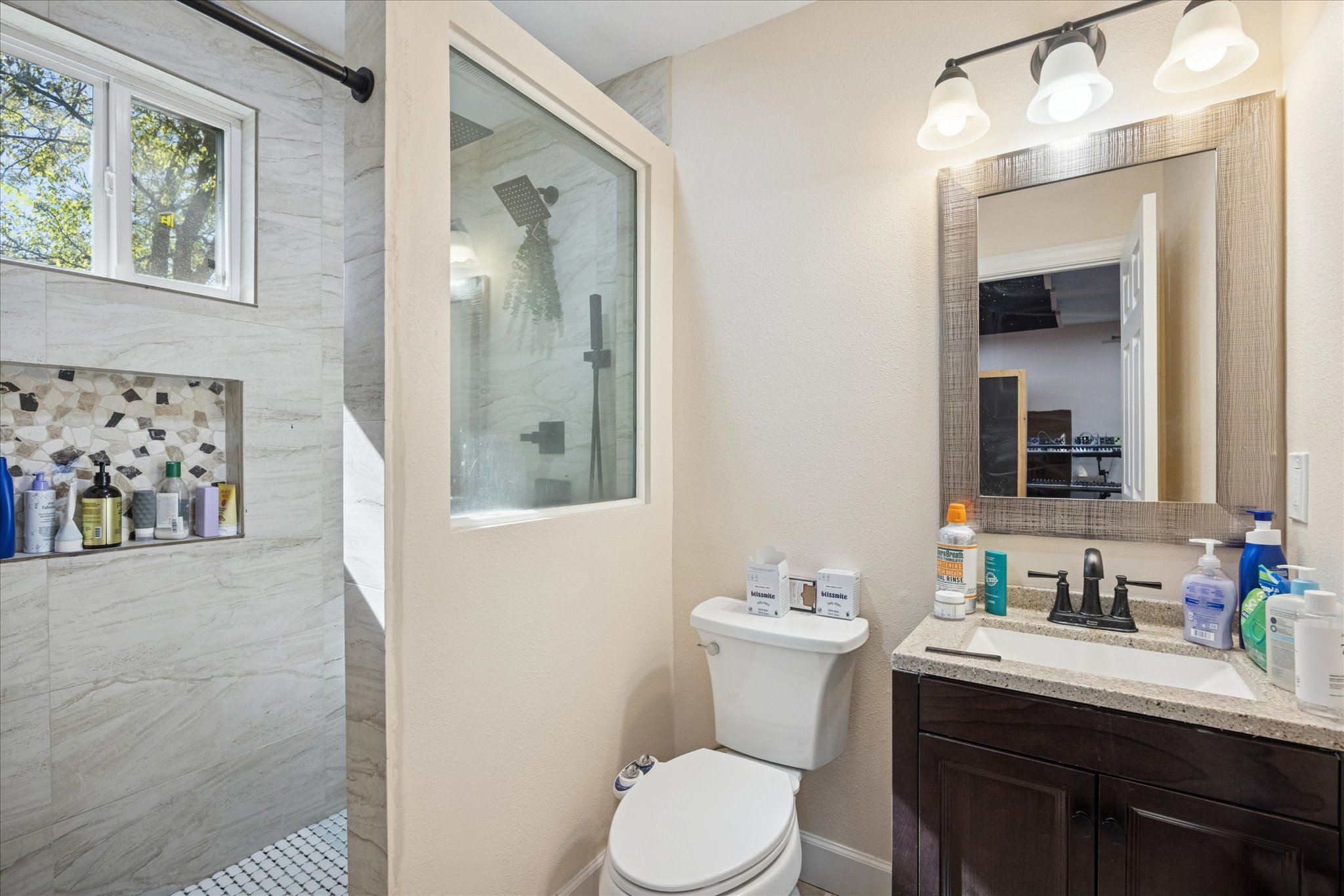 907 East 53rd Street Austin, TX 78751 - Photo 22 of 35 a bathroom with a toilet sink and mirror
