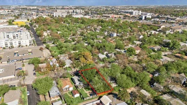a view of backyard with wooden fence
