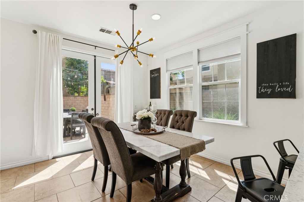 4155 Windspring Street Corona, CA 92883 - Photo 12 of 38 a view of a dining room with furniture window and outside view