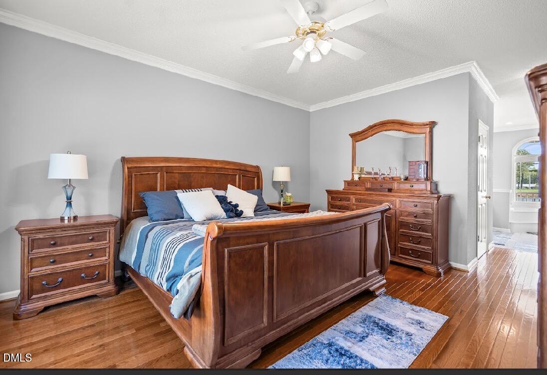 5780 McArthur Road Broadway, NC 27505 - Photo 23 of 40 a bedroom with a bed and a chandelier