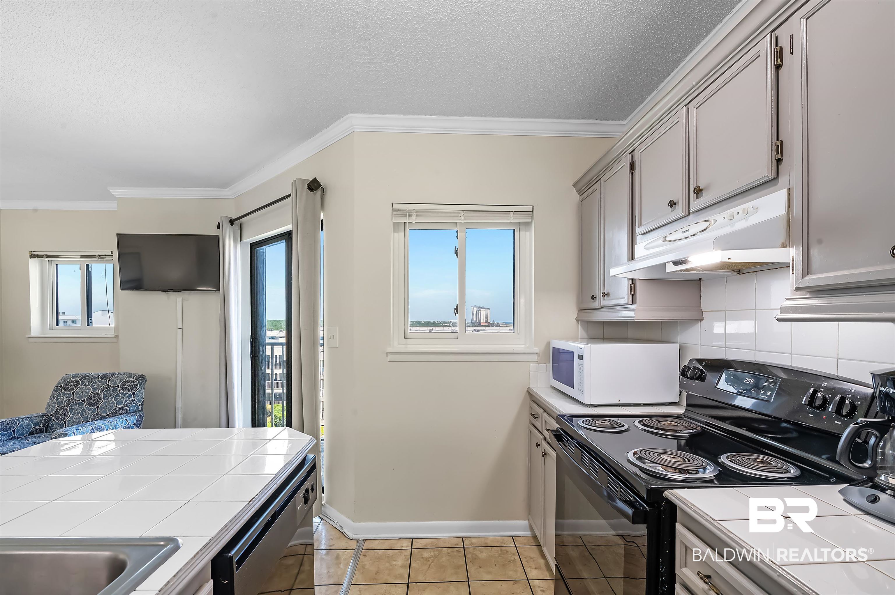 375 Plantation Road, Unit 5409 Gulf Shores, AL 36542 - Photo 13 of 48 Kitchen featuring electric range, stainless steel dishwasher, tile countertops, and light tile patterned floors