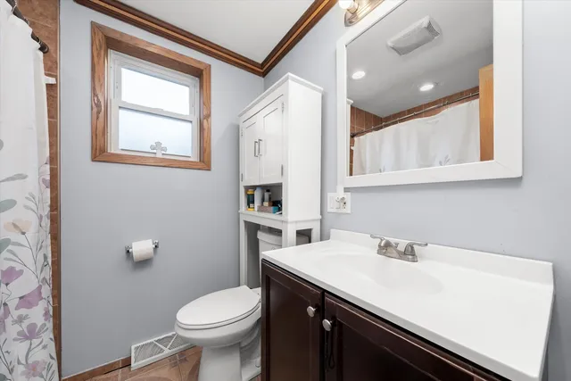 a bathroom with a sink a toilet and mirror