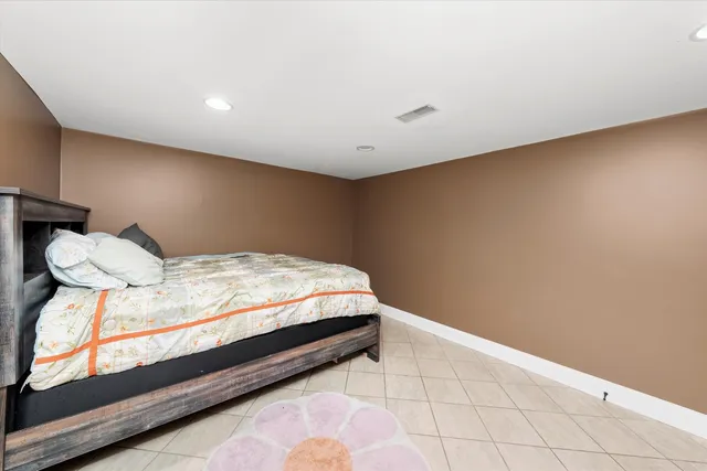 a bedroom with a bed and dresser