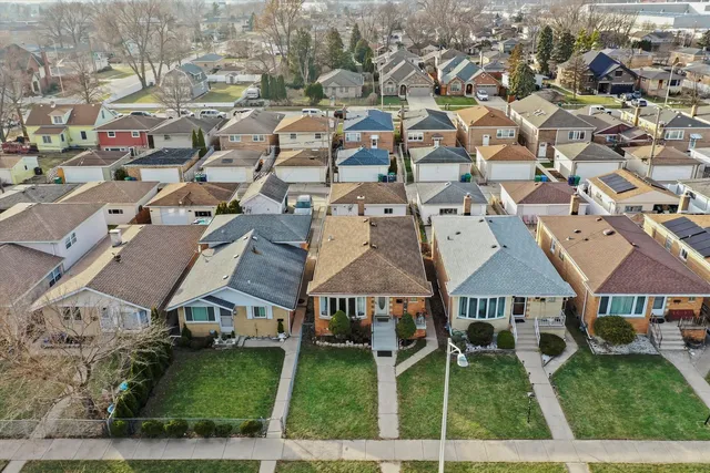an aerial view of residential houses with outdoor space
