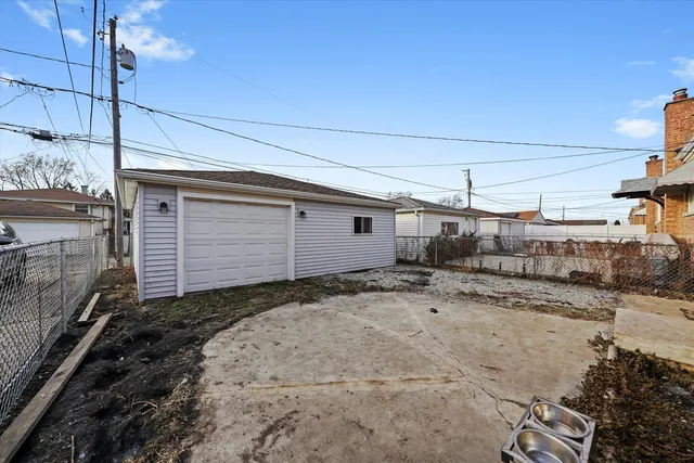 a front view of a house with a yard and potted plants
