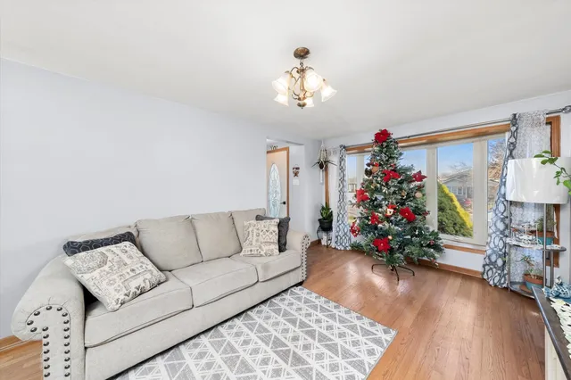 a living room with furniture and a chandelier