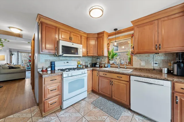 a kitchen with stainless steel appliances granite countertop a stove sink and cabinets