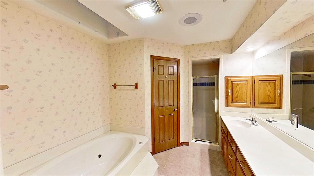 509 Topside Drive Azle, TX 76020 - Photo 11 of 19 a bathroom with a tub sink shower and a mirror