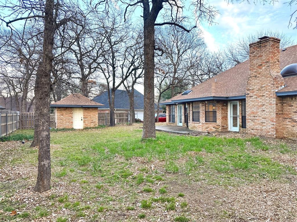 509 Topside Drive Azle, TX 76020 - Photo 16 of 19 a view of a yard in front of a house with large trees