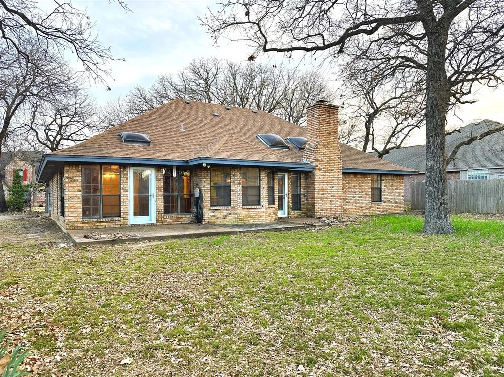 509 Topside Drive Azle, TX 76020 - Photo 17 of 19 a front view of a house with a garden and porch