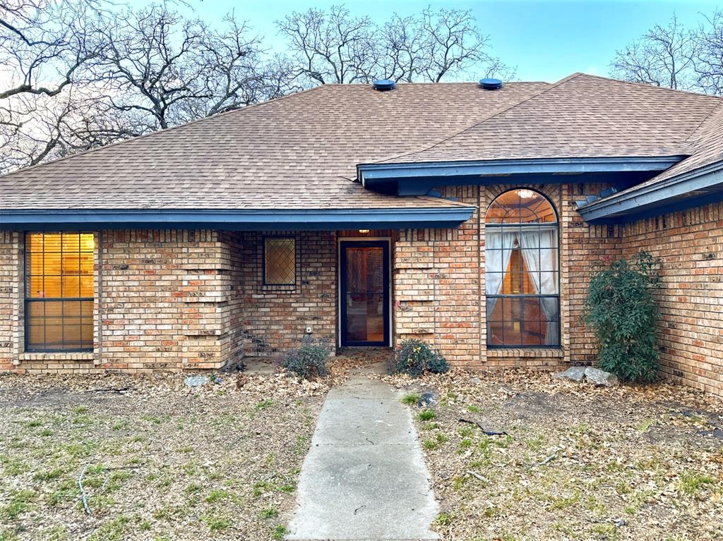 509 Topside Drive Azle, TX 76020 - Photo 2 of 19 a front view of a house with garden