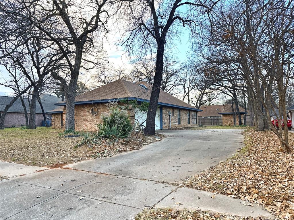 509 Topside Drive Azle, TX 76020 - Photo 4 of 19 a tree in front of a white house