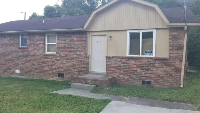 a front view of a house with brick walls