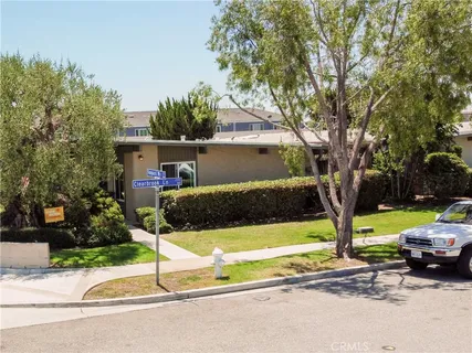 a view of a patio with a table and chairs under an umbrella