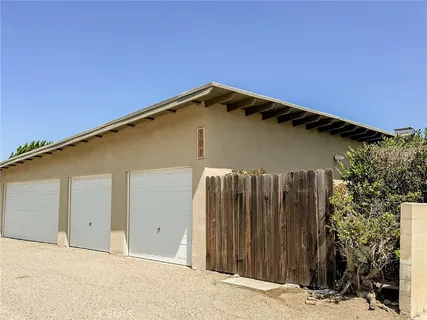 a view of a house with a wooden fence