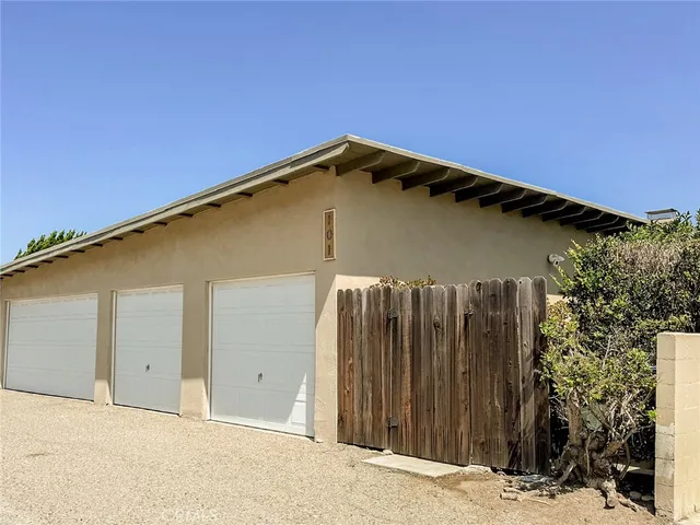 a view of a house with a wooden fence