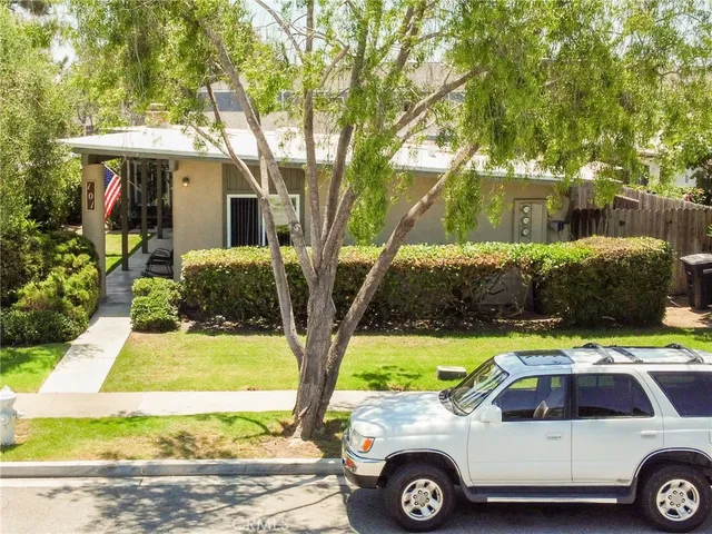 a view of a house with car parked