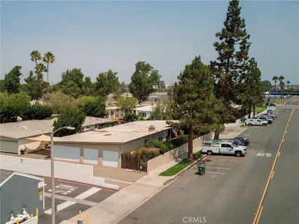 a view of a white house with a swimming pool and sitting area