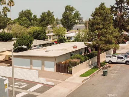 a view of a patio with table and chairs with wooden fence and plants