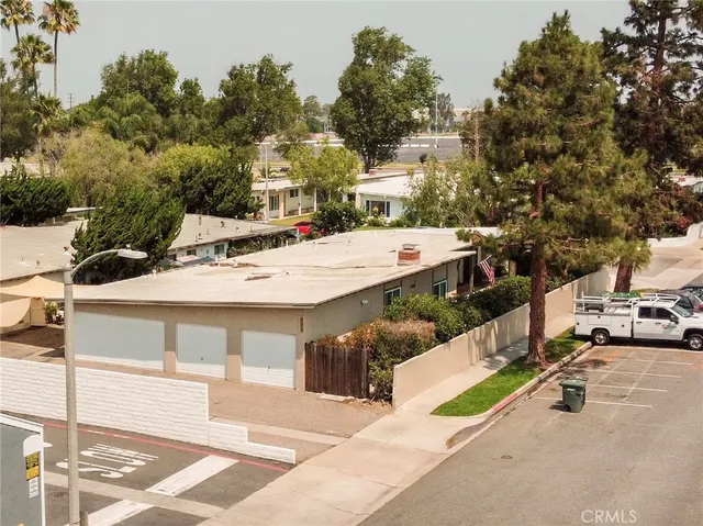 a view of a patio with table and chairs with wooden fence and plants
