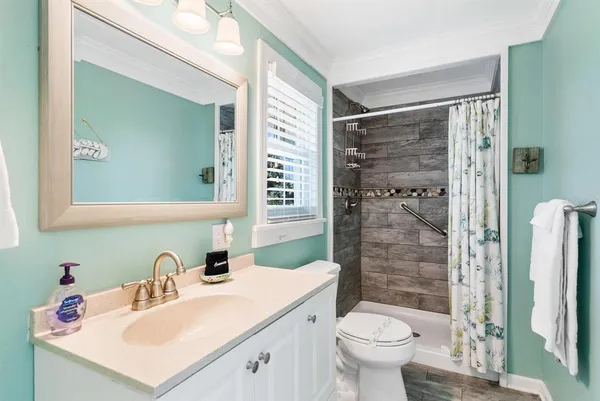 a bathroom with a sink toilet and shower
