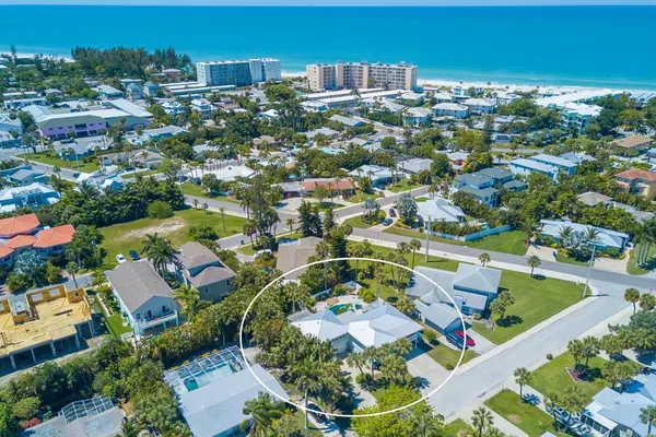 an aerial view of residential houses with outdoor space and swimming pool