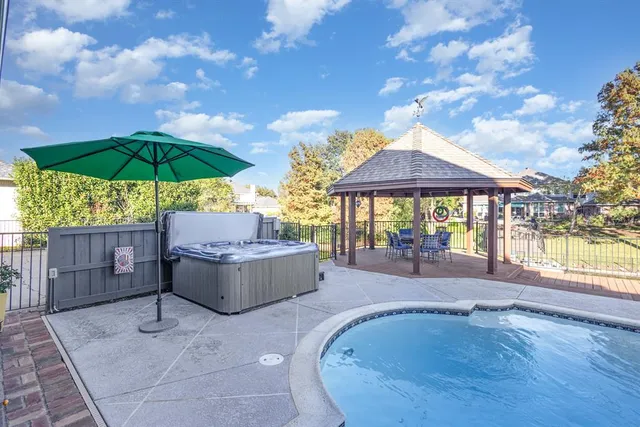 an aerial view of a house with swimming pool garden and mountain view