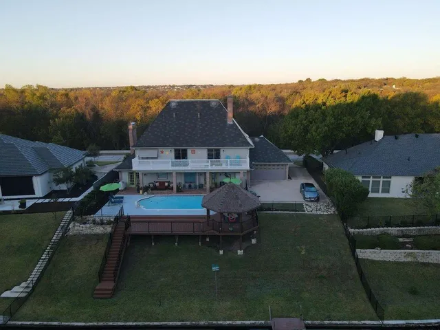 an aerial view of house with outdoor space and garden