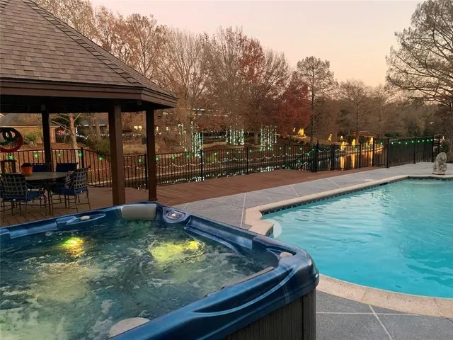 a view of a swimming pool with an outdoor seating