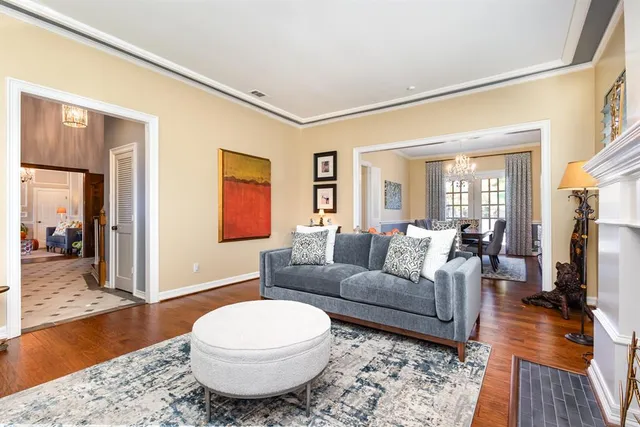 a living room with furniture a wooden floor and a fireplace