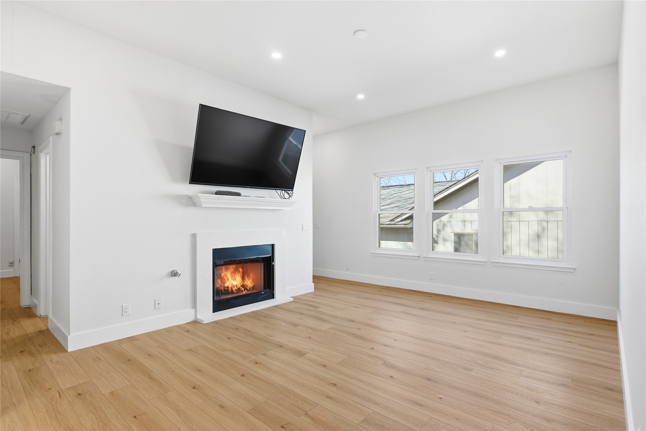 9019 Wellesley Drive Austin, TX 78754 - Photo 3 of 23 a view of an empty room with wooden floor and a window