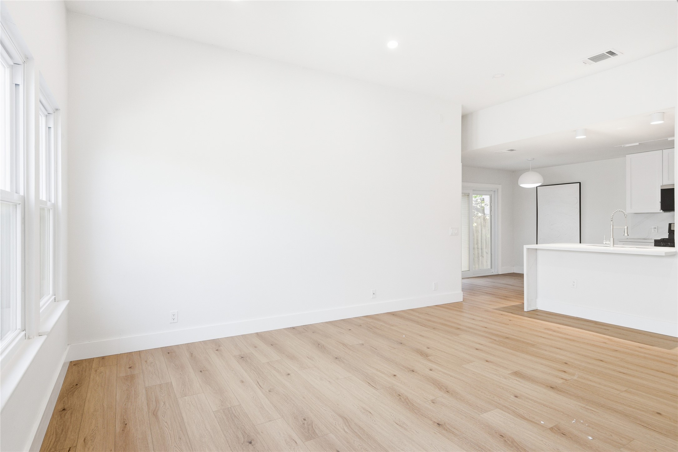 9019 Wellesley Drive Austin, TX 78754 - Photo 4 of 23 an empty room with wooden floor and a window