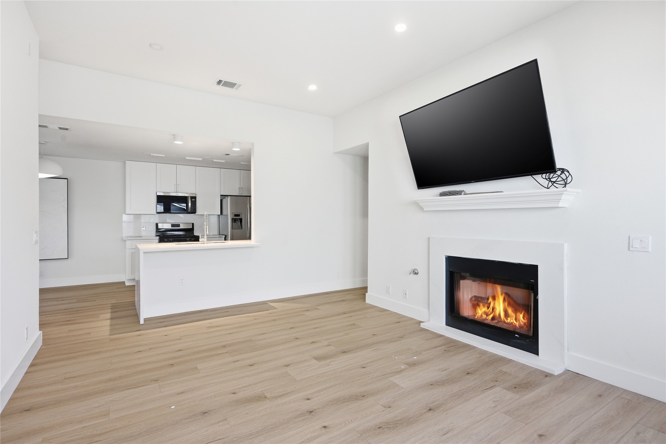 9019 Wellesley Drive Austin, TX 78754 - Photo 5 of 23 a view of a living room a flat screen tv and a fireplace