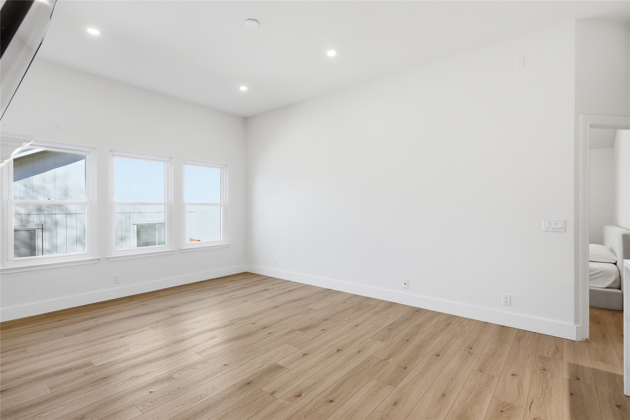 9019 Wellesley Drive Austin, TX 78754 - Photo 7 of 23 an empty room with wooden floor and windows