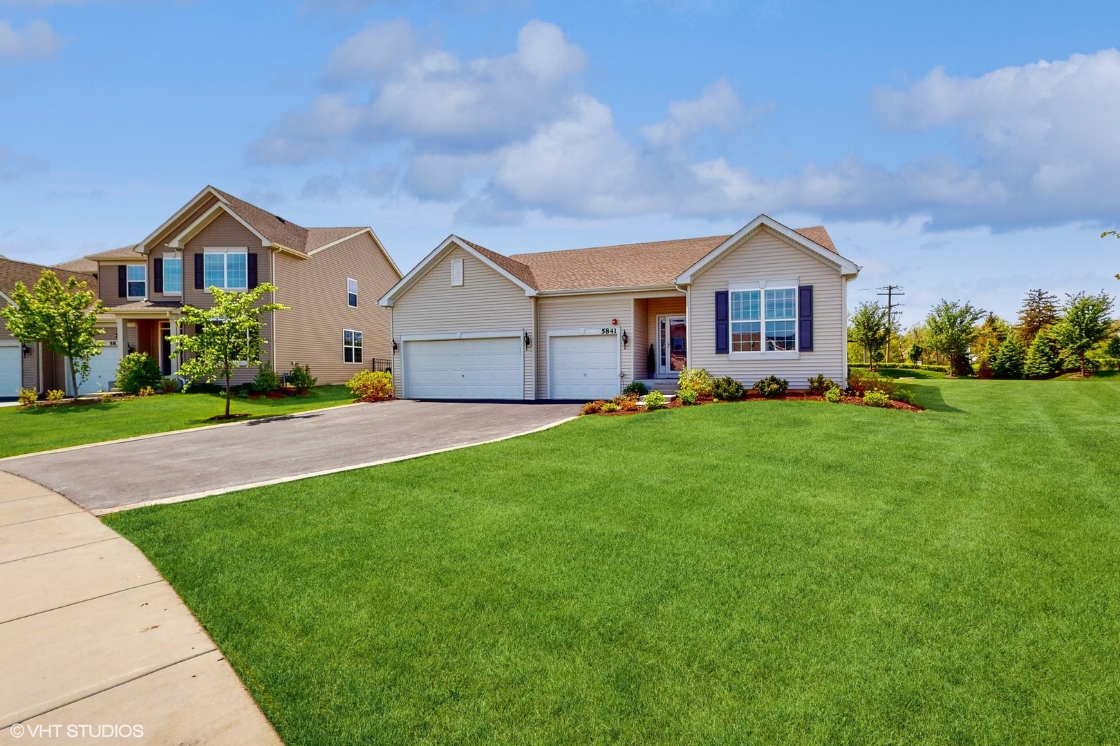 a front view of house with yard and green space