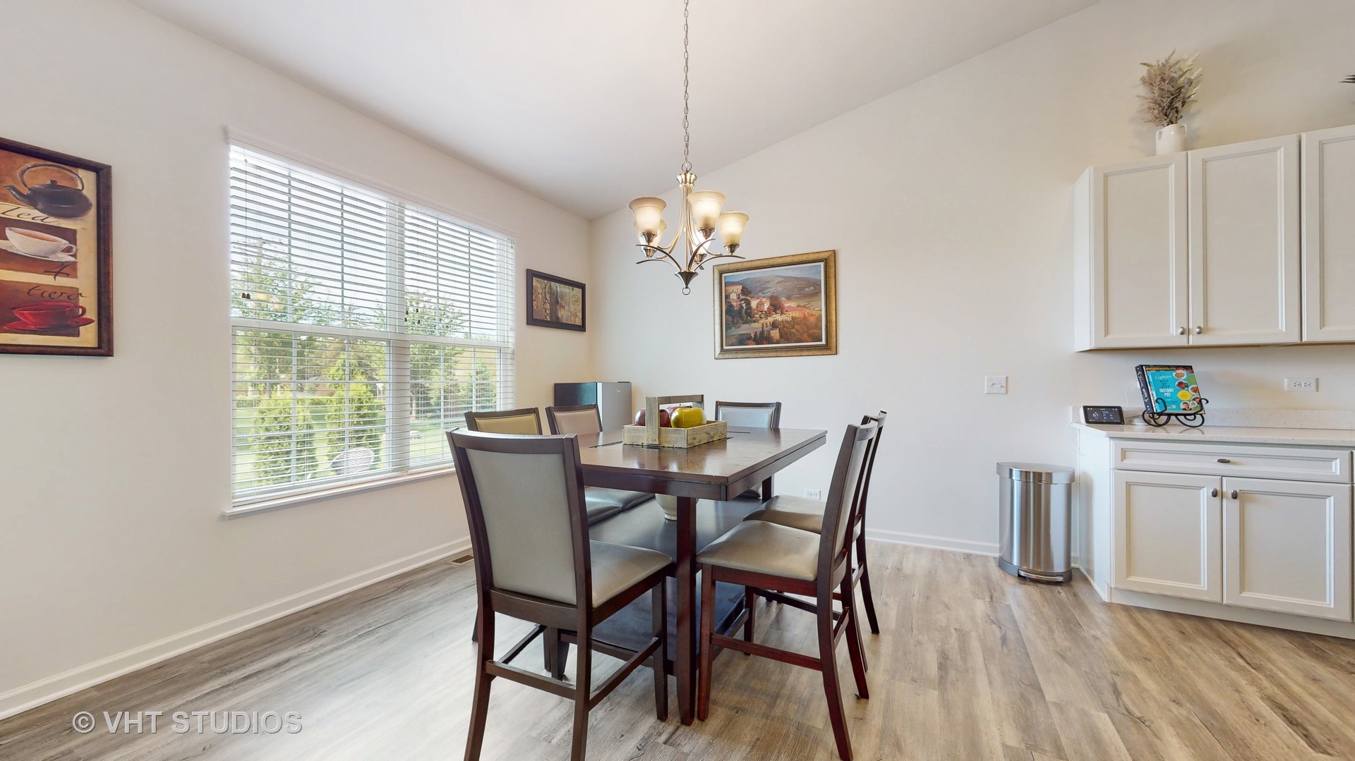 5841 Fairview Lane Hoffman Estates, IL 60192 - Photo 10 of 35 a dining room with furniture a chandelier and wooden floor