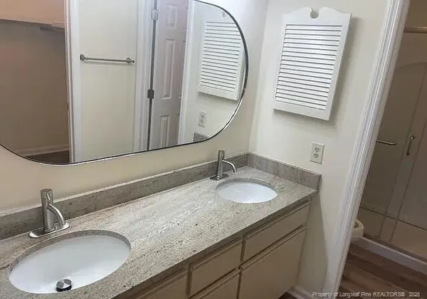 a bathroom with a glass door shower