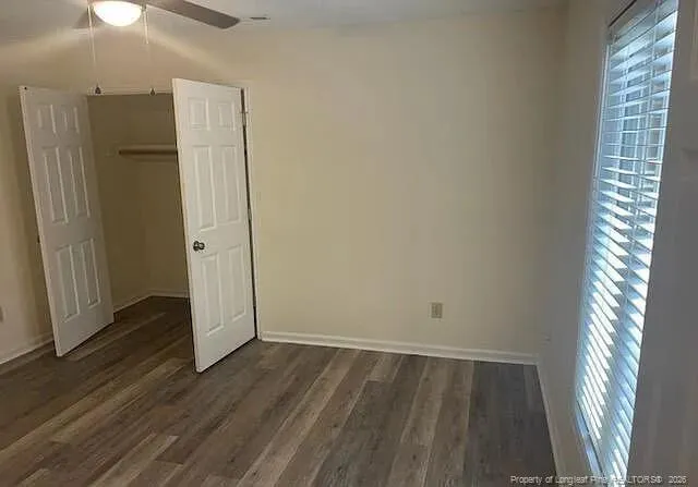 a bathroom with a granite countertop toilet and a bathtub