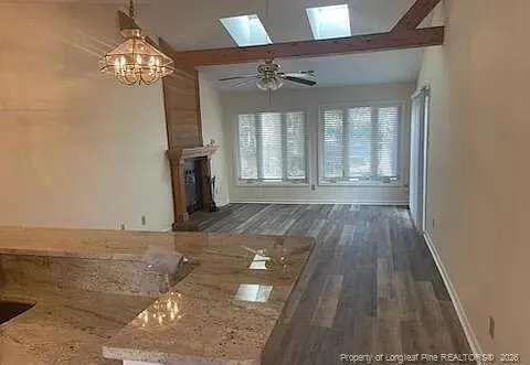 a view of a livingroom with wooden floor and a large window