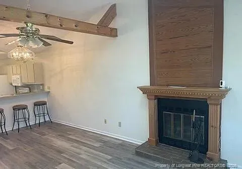 a view of a livingroom with furniture and chandelier fan