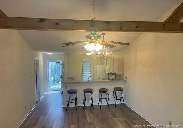 a view of a kitchen with a table and chairs