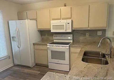 a kitchen with stainless steel appliances white cabinets and a sink