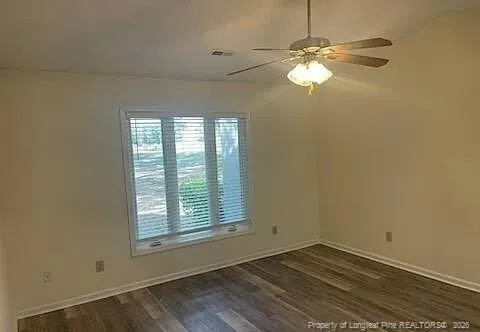 a view of a hallway with wooden floor and chandelier