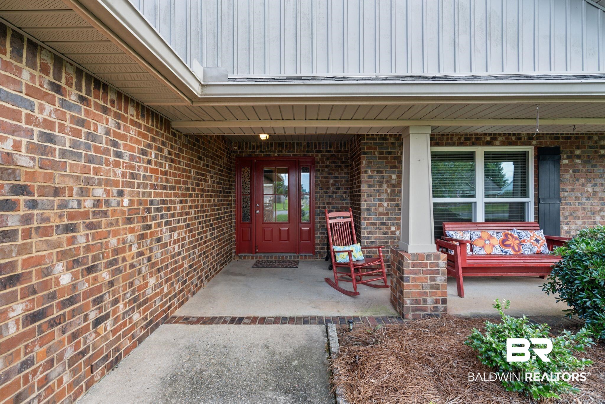 562 Vestige Mews Foley, AL 36535 - Photo 5 of 54 Brick exterior facade with a covered porch entry