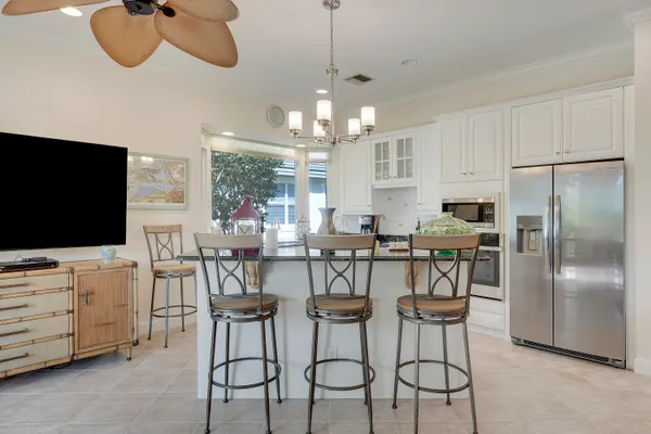 a living room with furniture kitchen view and a flat screen tv